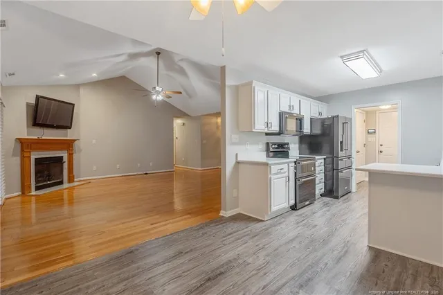 a kitchen with stainless steel appliances a stove top oven a sink and a refrigerator