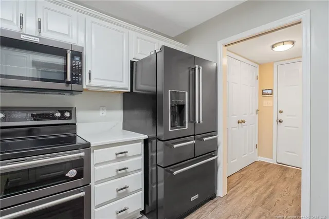 a kitchen with stainless steel appliances and wooden cabinets