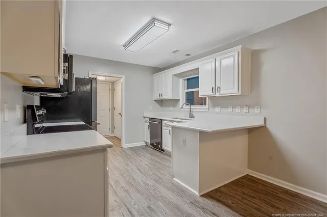 a kitchen with a sink stove and refrigerator