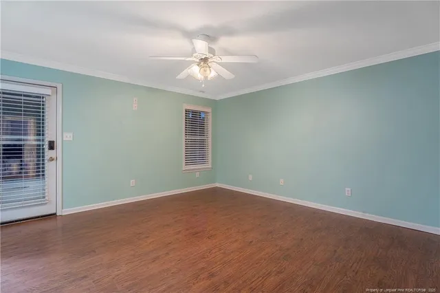 en empty room with windows and fan