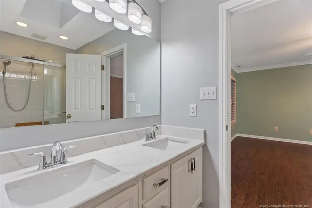 a bathroom with a sink double vanity and a mirror