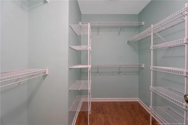 a view of walk in closet with empty racks