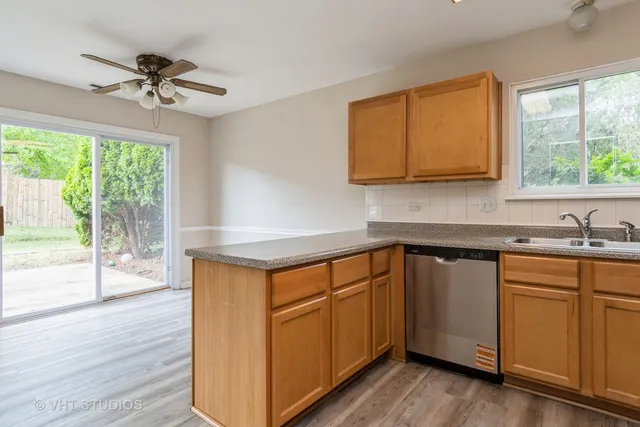 a kitchen with a sink cabinets and wooden floor