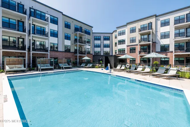 a house view with swimming pool and sitting space
