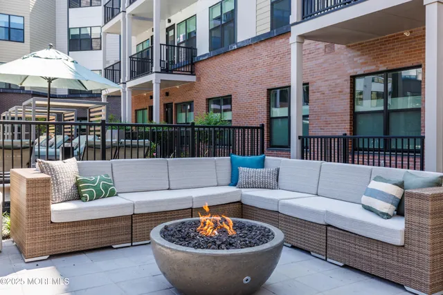 a view of a patio with couches and a potted plant