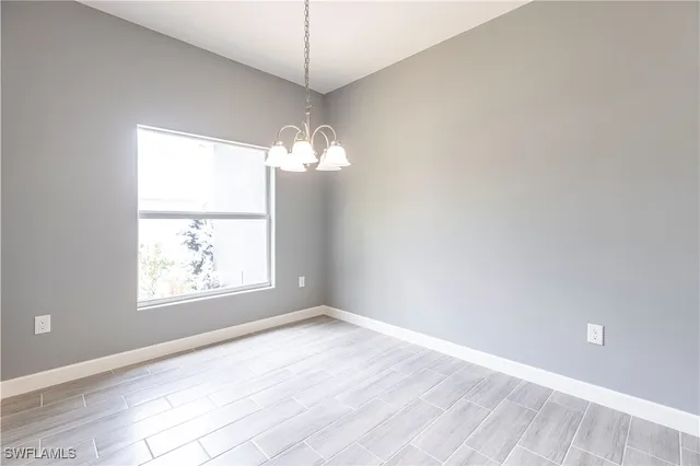 a view of a kitchen with a sink and dishwasher a refrigerator with wooden floor