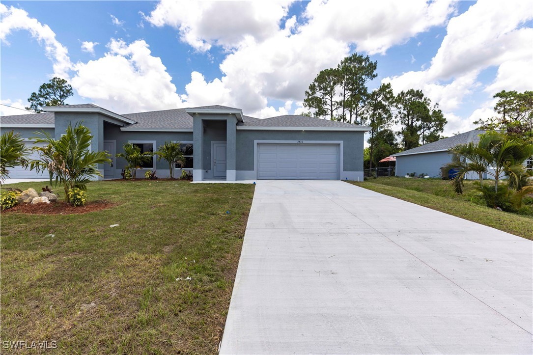 4723 30th Street Southwest Lehigh Acres, FL 33973 - Photo 3 of 29 front view of a house with a yard and potted plants
