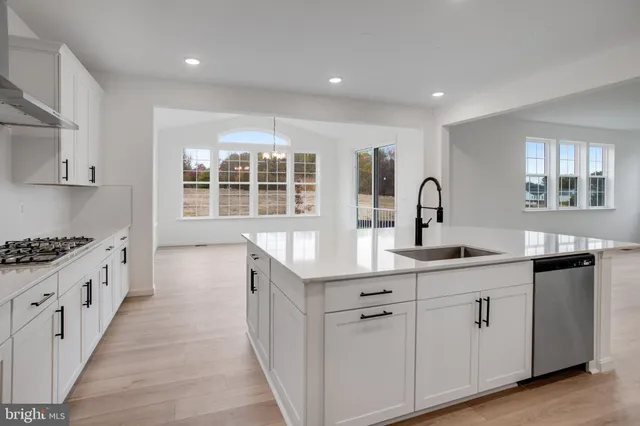 a kitchen with stainless steel appliances granite countertop a stove and a sink