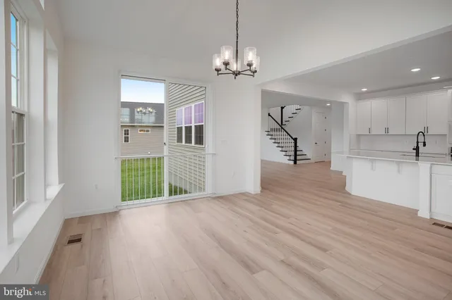 a view of a kitchen with a dishwasher cabinets and wooden floor