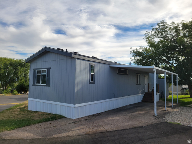 156 Cushing Way Layton, UT 84041 - Photo 3 of 20 Single-story residence featuring light gray siding, white trim, a carport, and a sloped roof