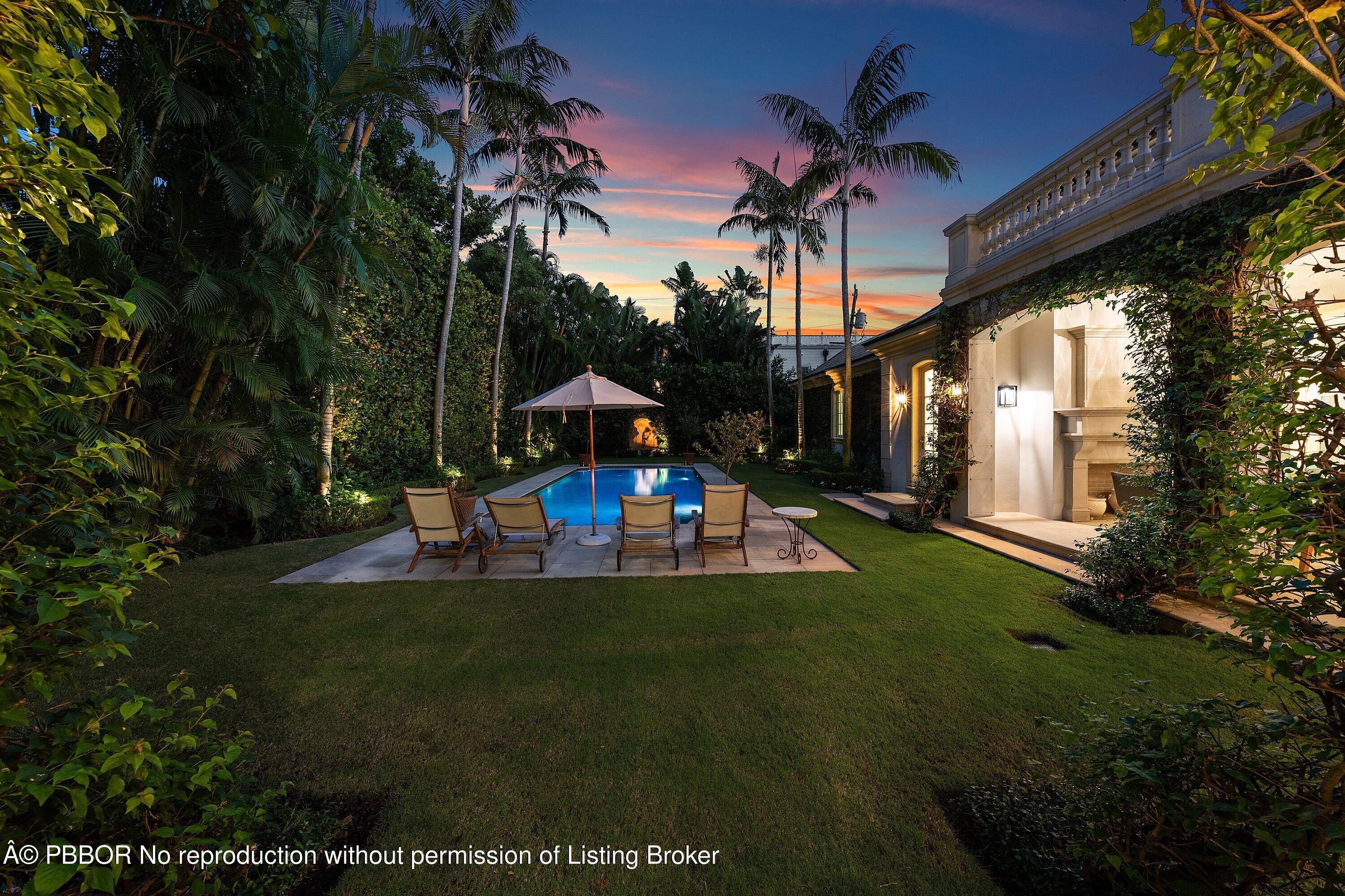 242 Wells Road Palm Beach, FL 33480 - Photo 46 of 54 a view of swimming pool with a table and chairs under an umbrella