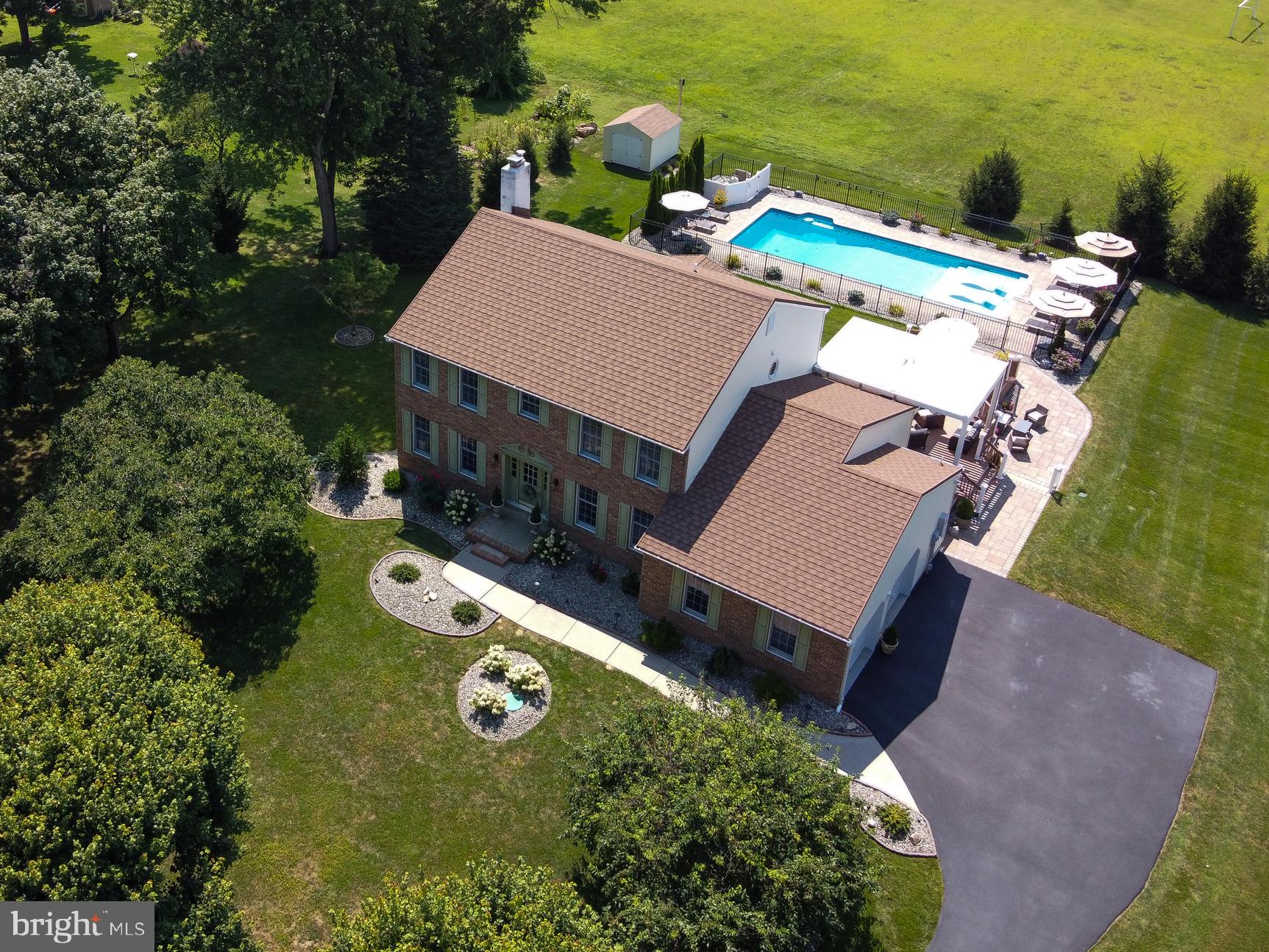 an aerial view of a house with swimming pool and ocean view