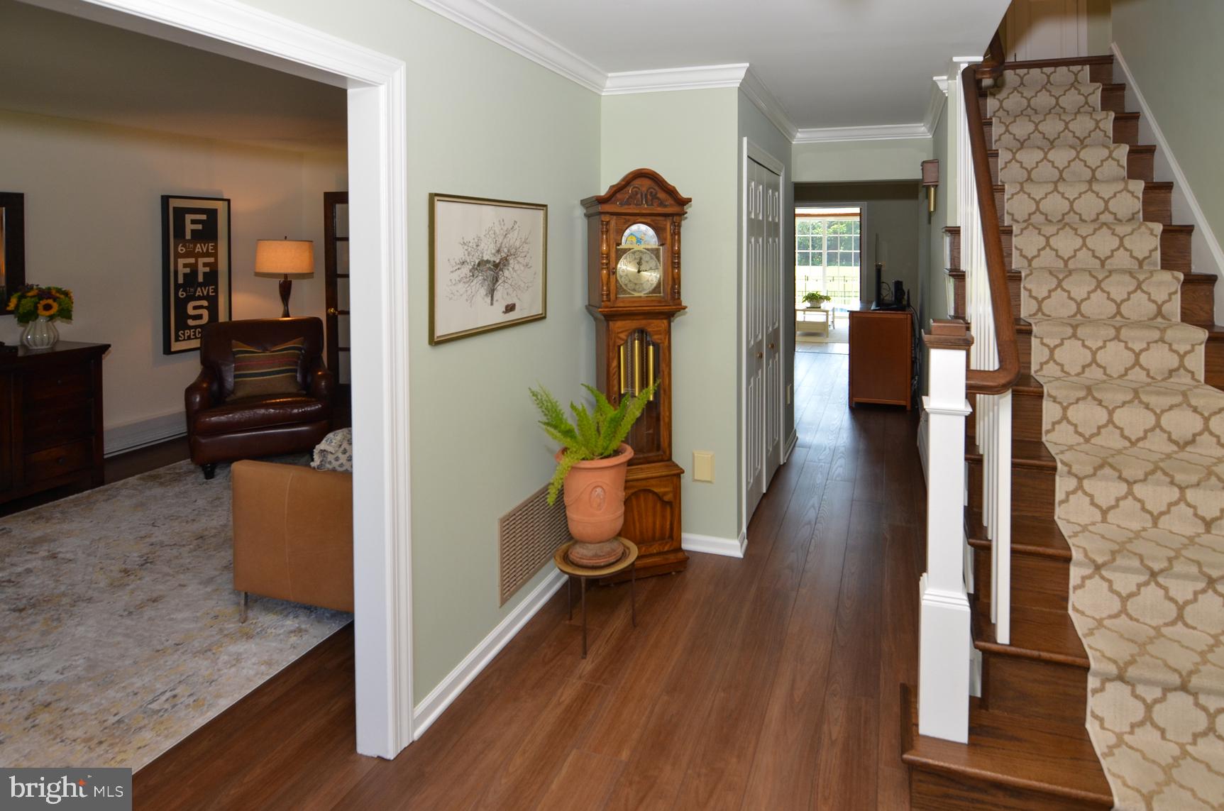 3 Aqua Terrace Hamilton, NJ 08620 - Photo 9 of 39 a hallway with wooden floor white walls and stairs
