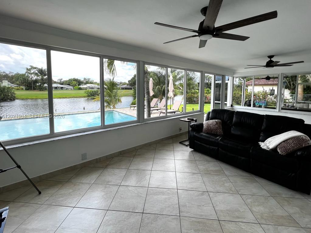 3324 Lakeview Boulevard Delray Beach, FL 33445 - Photo 10 of 36 a living room with furniture and a large window with kitchen view