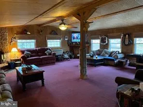 a living room with furniture and a dining area