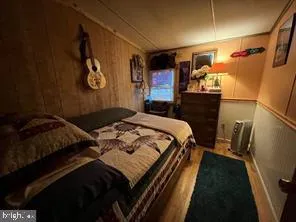 a bedroom with a bed and a mirror