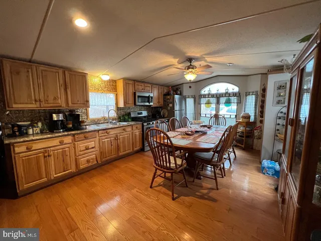 a kitchen with a dining table chairs and white cabinets
