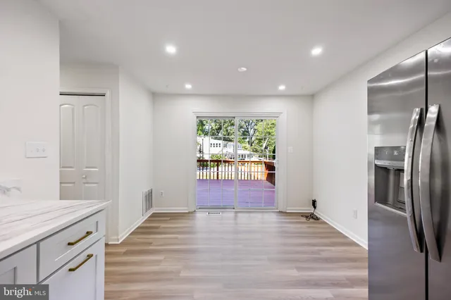 a view of a kitchen with a sink and dishwasher wooden floor
