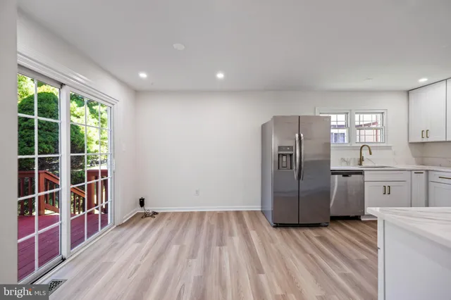 a kitchen with a refrigerator and cabinets