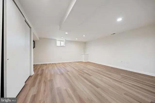 a view of an empty room and wooden floor