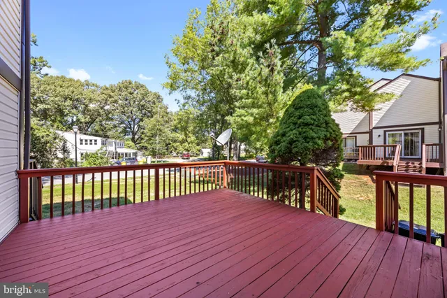 a balcony with wooden floor and outdoor space