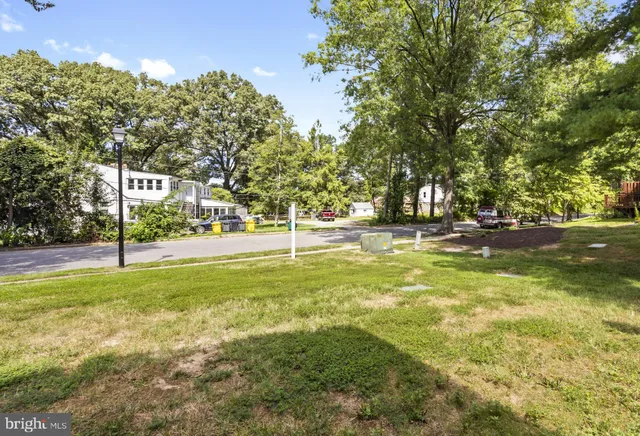 a view of yard with swimming pool and trees