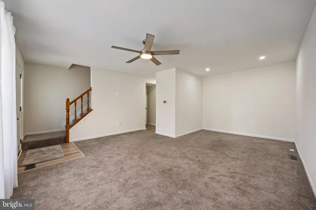 a view of an empty room with a ceiling fan