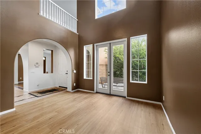 a view of an empty room with a window and fireplace
