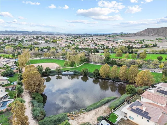 a view of a livingroom with wooden floor and stairs