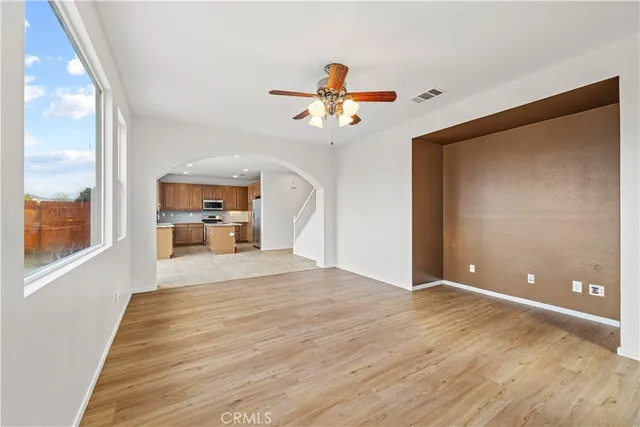 a kitchen with granite countertop a sink stainless steel appliances wooden cabinets and a window