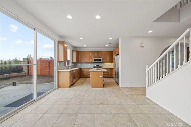 a kitchen with stainless steel appliances granite countertop sink stove and refrigerator