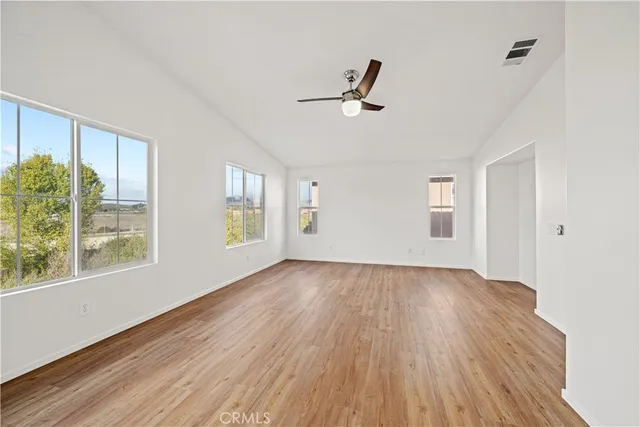 a view of a white house with a yard and garage