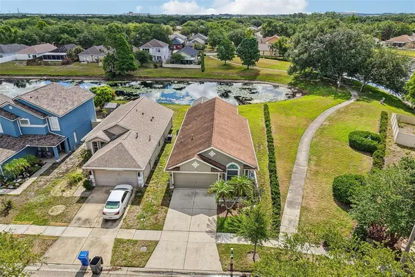 an aerial view of a house with a swimming pool yard and outdoor seating