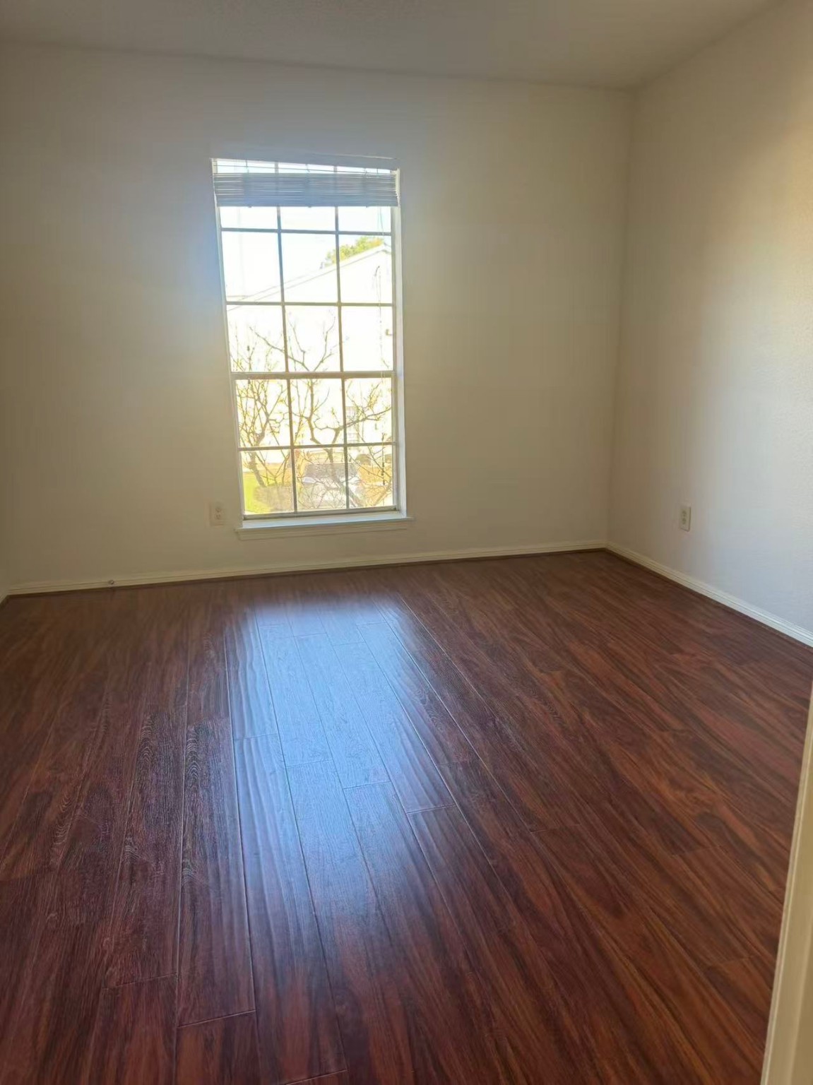 1515 Sandy Springs Road, Unit 2002 Houston, TX 77042 - Photo 14 of 19 an empty room with wooden floor and windows