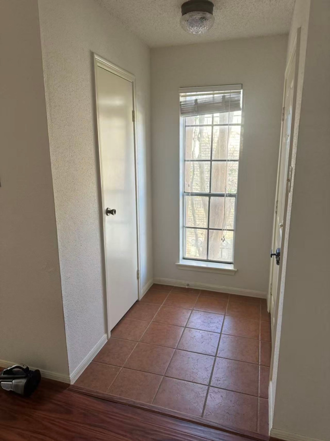 1515 Sandy Springs Road, Unit 2002 Houston, TX 77042 - Photo 17 of 19 a view of an empty room with wooden floor and a window