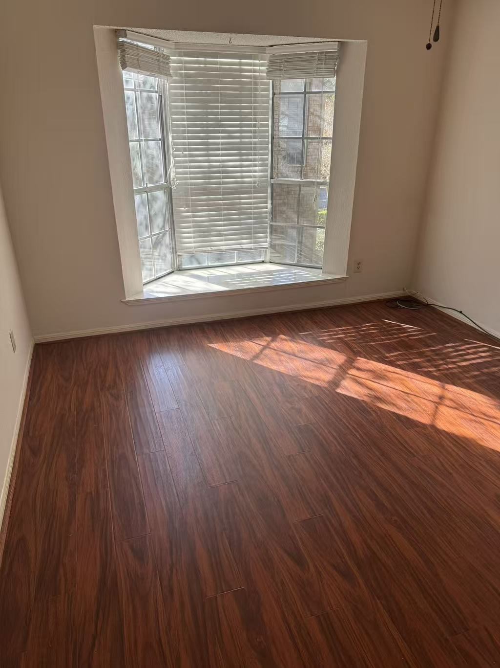 1515 Sandy Springs Road, Unit 2002 Houston, TX 77042 - Photo 8 of 19 an empty room with wooden floor and windows
