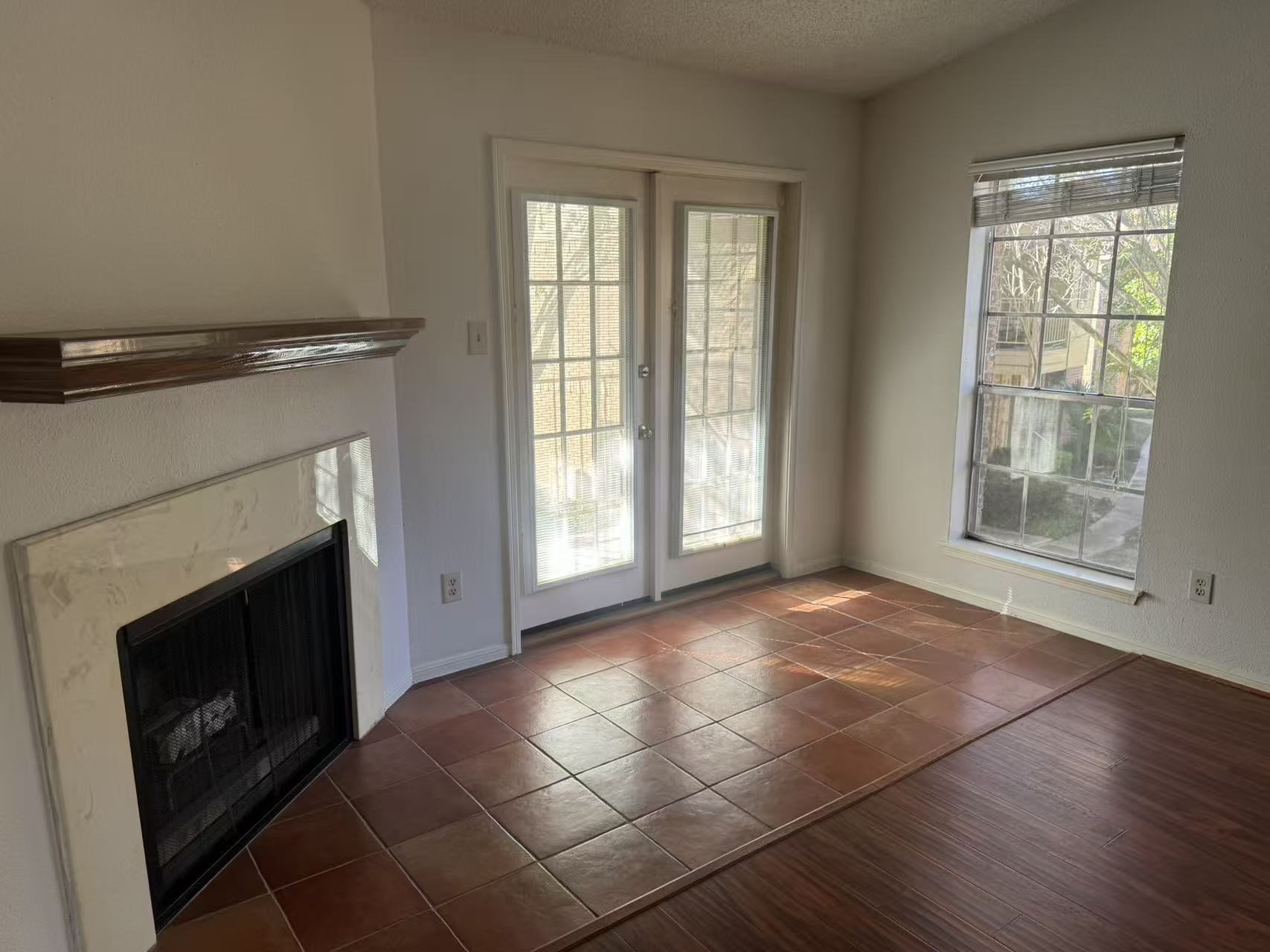 1515 Sandy Springs Road, Unit 2002 Houston, TX 77042 - Photo 9 of 19 an empty room with windows and fireplace