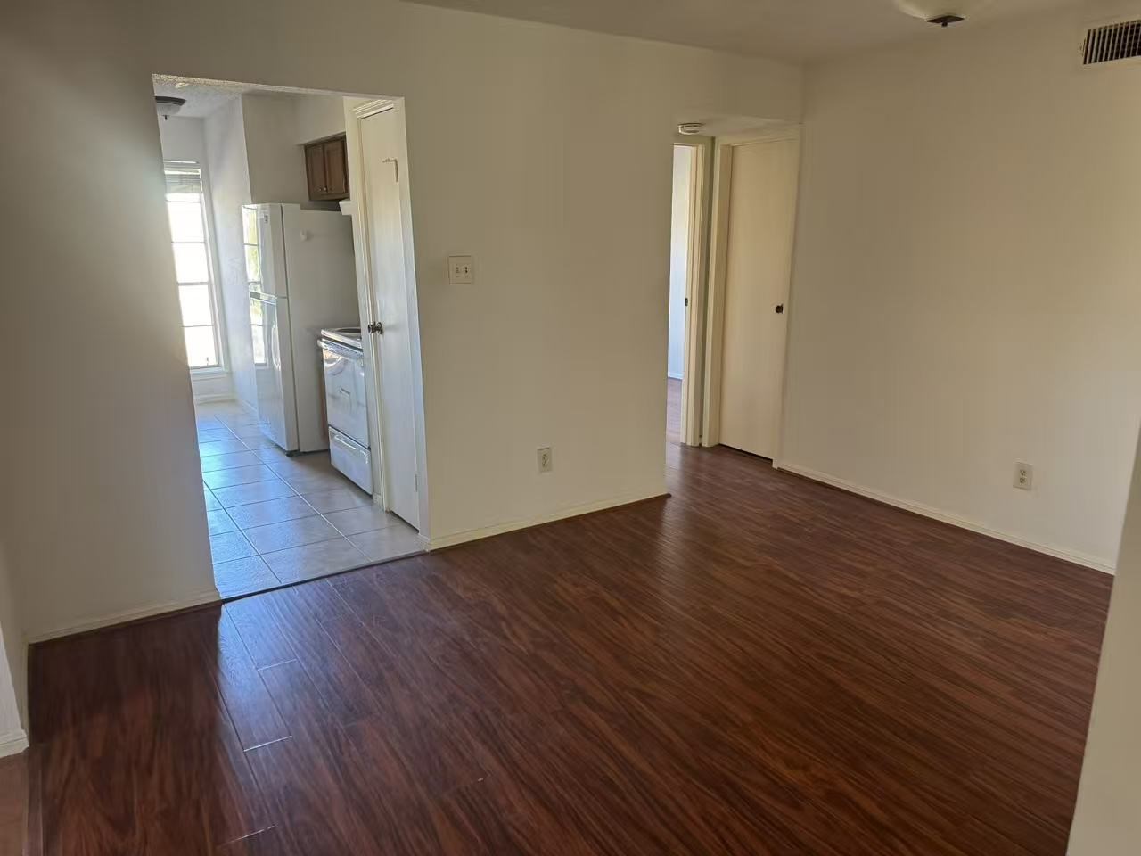 1515 Sandy Springs Road, Unit 2002 Houston, TX 77042 - Photo 10 of 19 an empty room with wooden floor and a bathroom