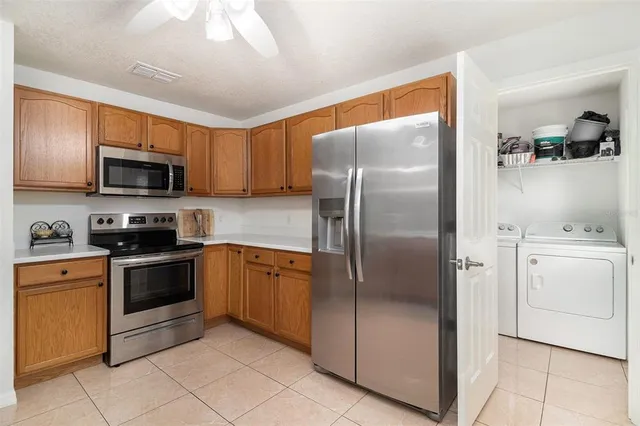 a kitchen with a refrigerator sink and microwave