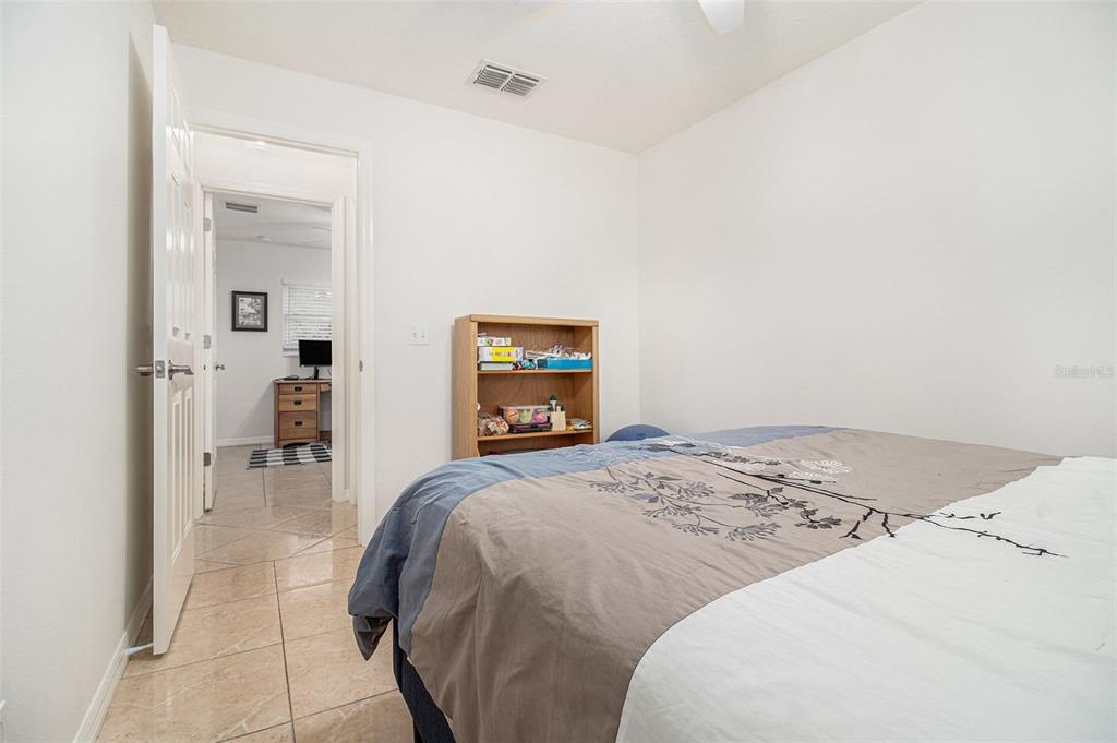 237 California Avenue St. Cloud, FL 34769 - Photo 17 of 26 a bedroom with a bed and a chair
