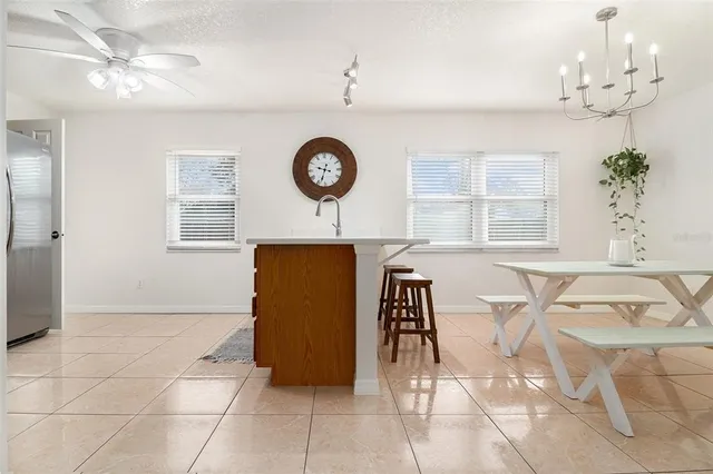 a view of a dining room with furniture and chandelier