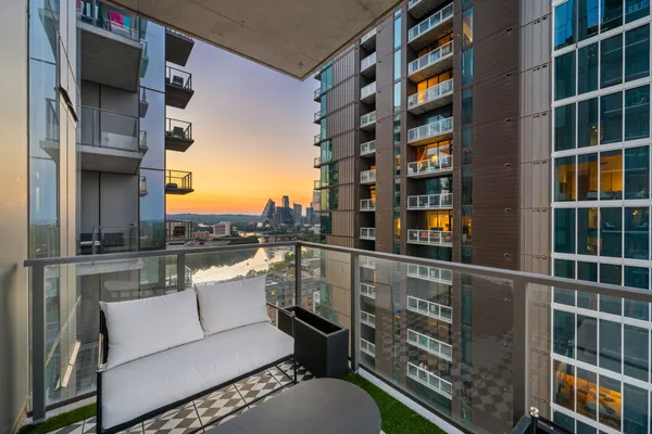 a view of roof deck with building and glass windows