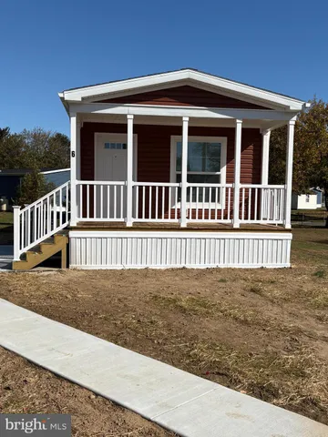a view of a house with a wooden deck