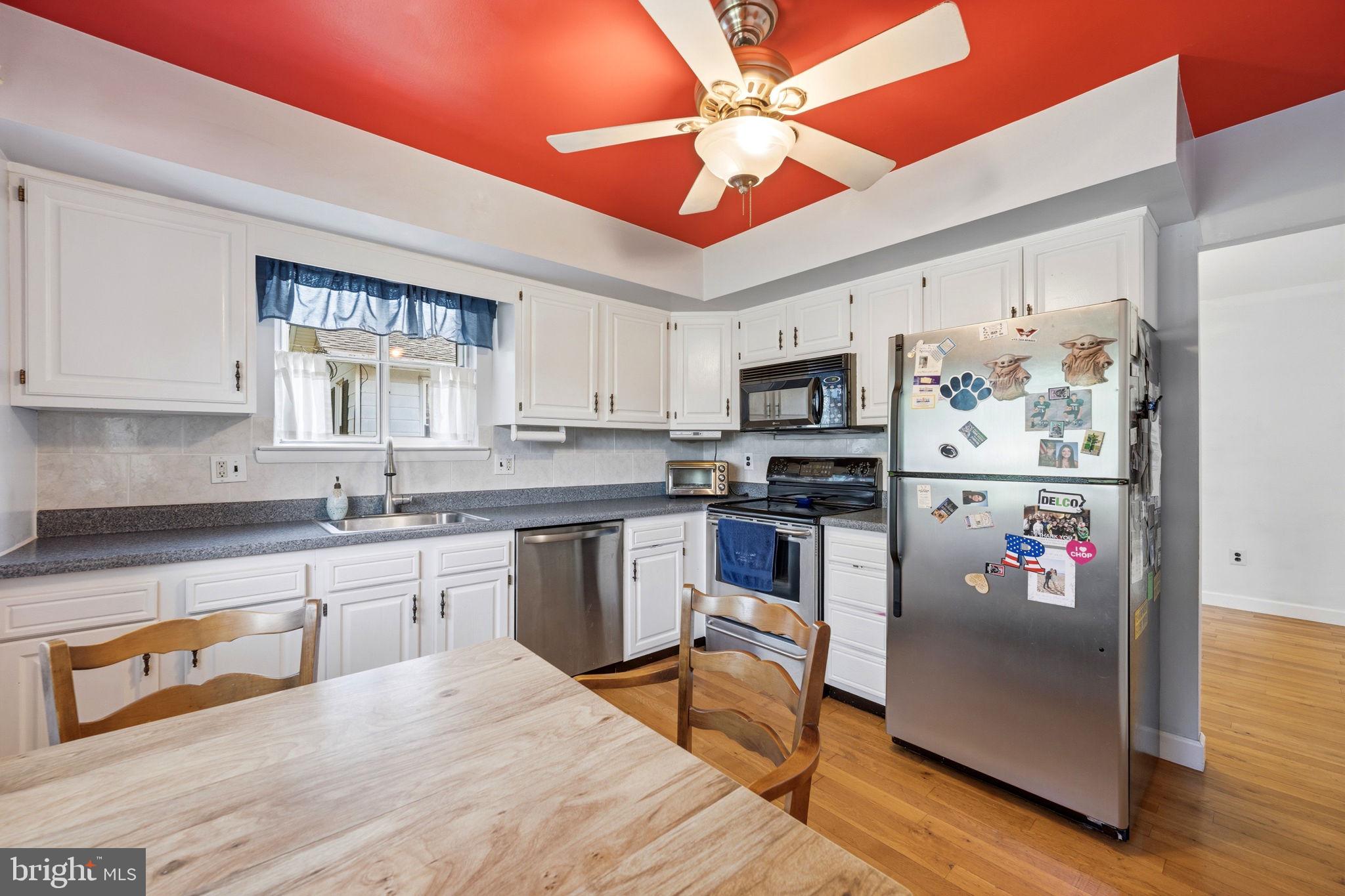 905 Amosland Road Morton, PA 19070 - Photo 17 of 44 Bright kitchen with bold red accents.