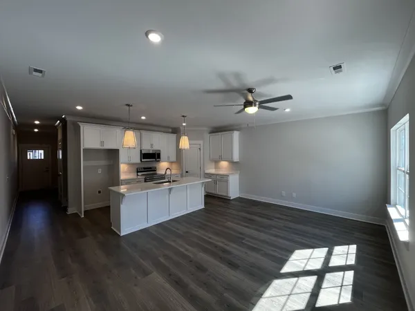 a view of kitchen with sink microwave and stove