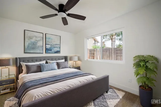a view of empty room with window and ceiling fan
