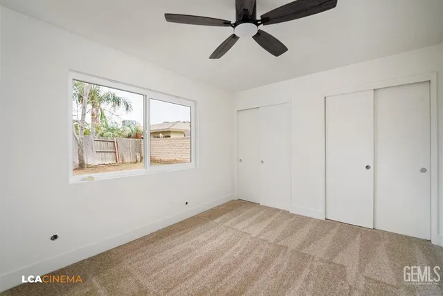 a view of room with window and ceiling fan