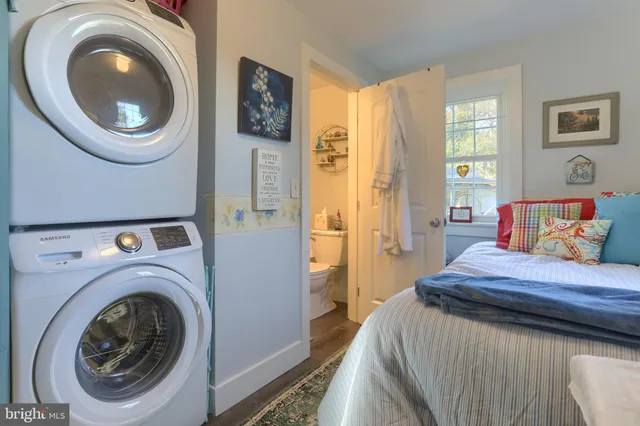 a bedroom with a washer and dryer