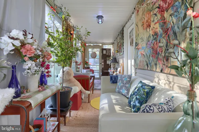 a living room with furniture and flowers