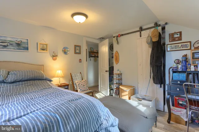 a bedroom with a bed and a book shelf